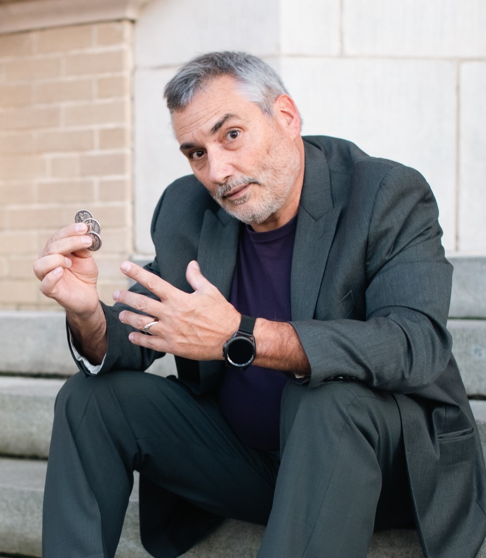 James R. Bentley — CEO of Wonder, professional close-up magician holding coins